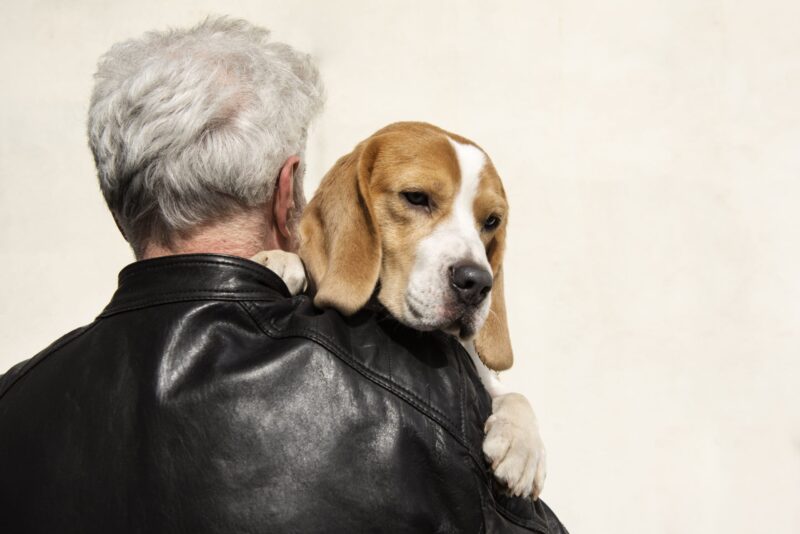 OLD PERSON WITH THEIR PET DOG